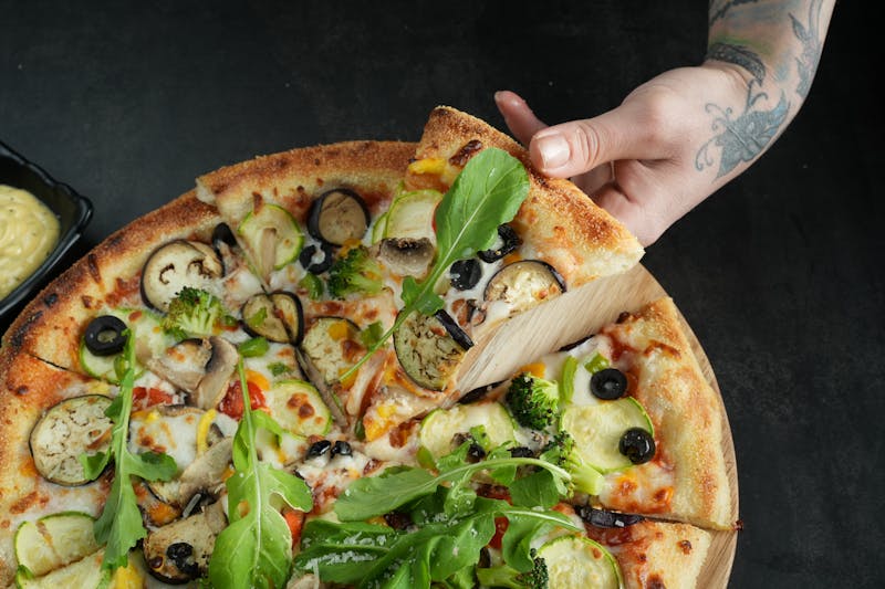 Pizza boxes ready for delivery stacked on a counter
